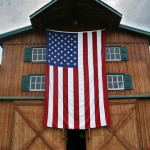 U.S. flag hanging on a barn